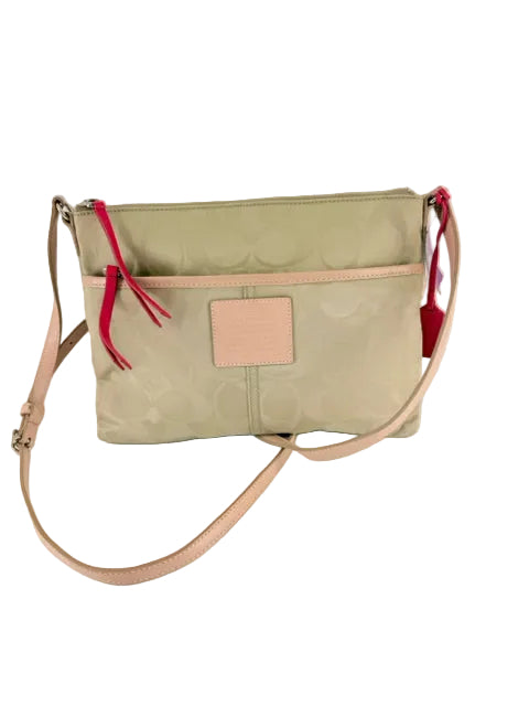 Coach Nylon Crossbody Bag in beige with all over logo print and pink strap detailing.