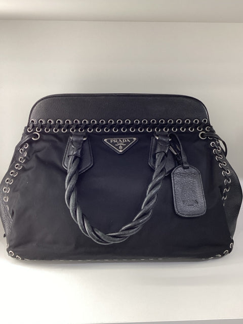 Prada Large Shoulder Bag Nylon Black

Metal Grommets around the edge of leather and nylon 

Black Interior with Prada Lettering

Silver toned Hardware